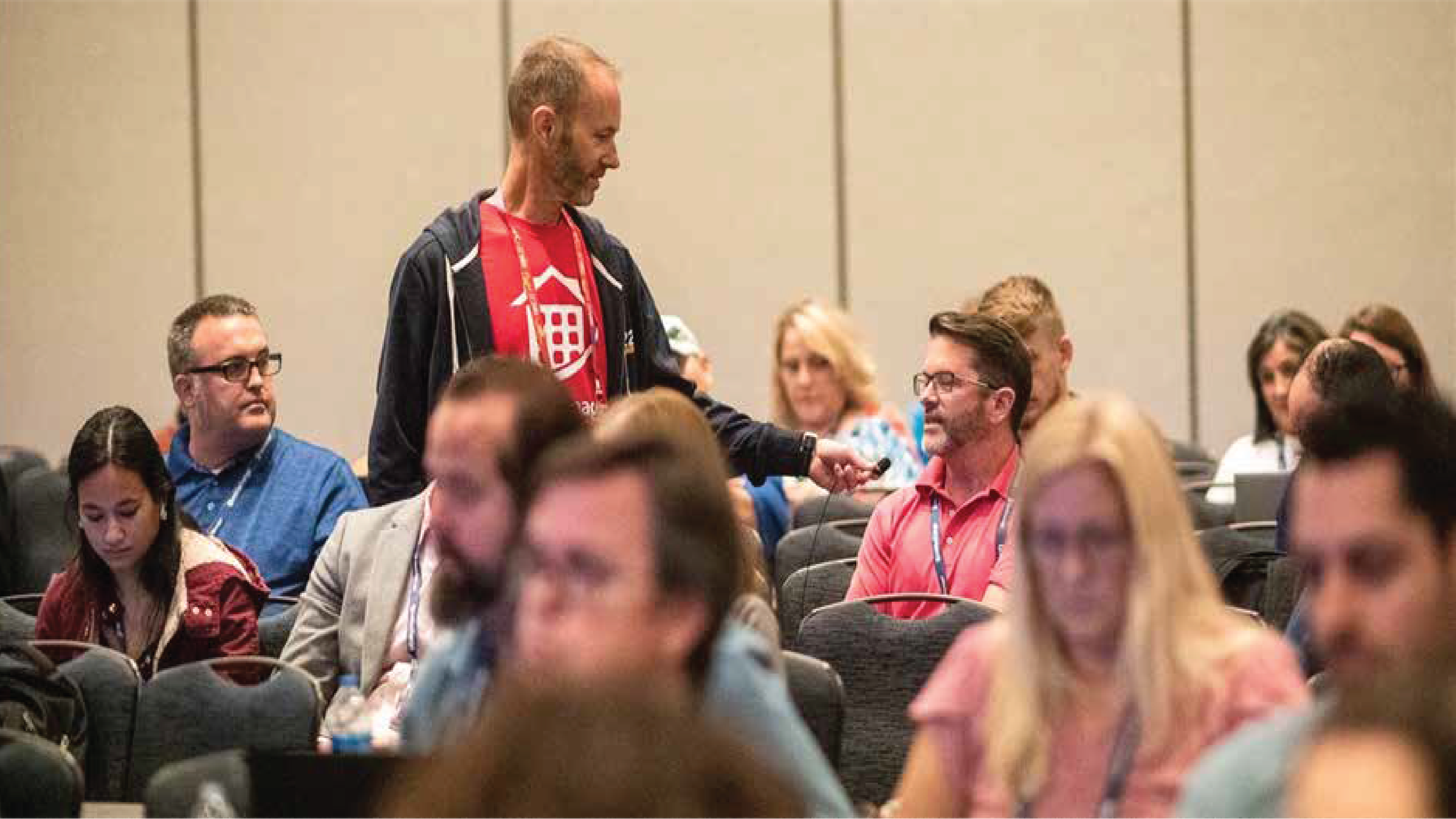 man asking audience member question